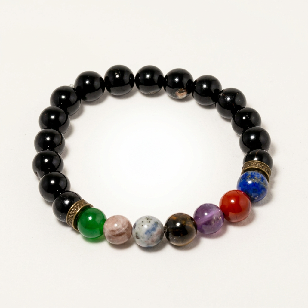 Handmade 7 Chakra bracelet with Tourmaline beads, styled on a matte background, highlighting natural stones and delicate design for protection and balancing.