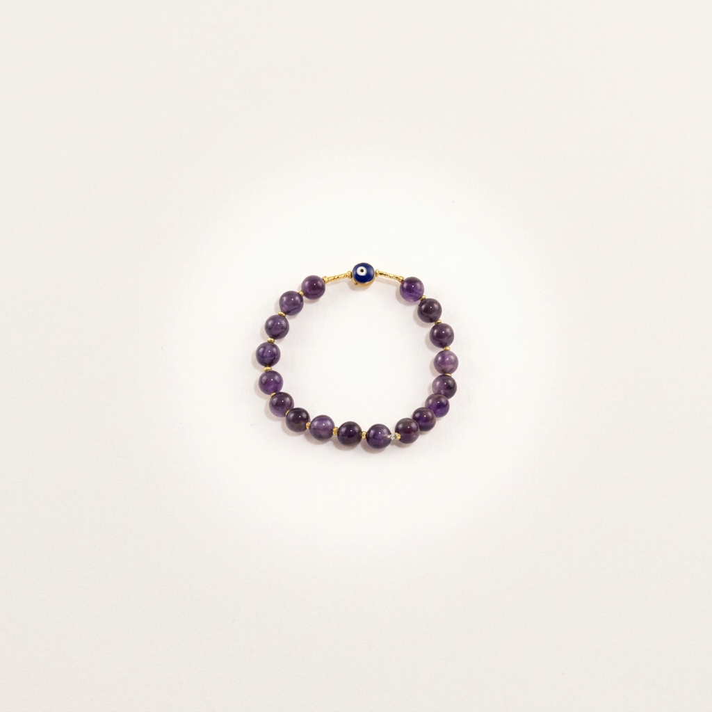 Close-up of amethyst evil eye Nazar bracelet on a matte background, highlighting its protective and healing properties in detailed jewelry photography.