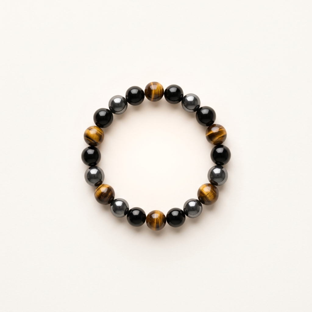 Detailed product photo of a delicate triple protection bracelet featuring Tiger Eye, Black Onyx, and Hematite beads on a matte background.